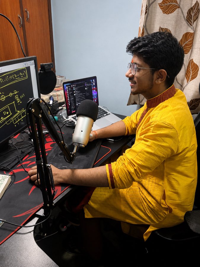 Vivek Gupta creating an educational video beside a microphone and computer screens